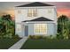 Charming two-story home with a well-manicured lawn, complemented by tropical landscaping and a picturesque sunset backdrop at 5044 Starling Bird Ln, St Cloud, FL 34771