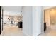 Bright hallway featuring tile floors leading to the living room and a bathroom with a shower and tub at 5044 Starling Bird Ln, St Cloud, FL 34771