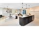 Open-concept kitchen features a large island, modern pendant lighting, and a seamless flow to the living area at 5044 Starling Bird Ln, St Cloud, FL 34771