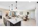 Kitchen with seating at island, modern lighting fixtures, and easy access to dining and living spaces at 5044 Starling Bird Ln, St Cloud, FL 34771