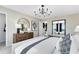 Bright main bedroom with a comfortable bed, natural light, stylish furniture, and access to the en suite at 5044 Starling Bird Ln, St Cloud, FL 34771