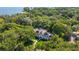 Aerial view of estate nestled among lush trees, highlighting pool and landscaping at 5100 Cranes Point Ct, Orlando, FL 32839