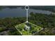 Stunning aerial view of grand estate home surrounded by lush landscaping and situated on a serene lakefront property at 5100 Cranes Point Ct, Orlando, FL 32839