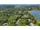 High angle view of a residential neighborhood in a wooded, lakeside setting at 5100 Cranes Point Ct, Orlando, FL 32839
