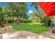 Expansive backyard featuring mature trees and lush landscaping, plus a brick patio at 5100 Cranes Point Ct, Orlando, FL 32839