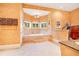 Luxurious bathroom featuring a soaking tub, chandelier, and sunny window views at 5100 Cranes Point Ct, Orlando, FL 32839