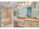 Bathroom featuring a vanity with granite countertop, tiled shower and adjacent tub at 5100 Cranes Point Ct, Orlando, FL 32839
