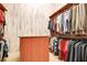 Organized walk-in closet with custom shelving and a central island offers ample storage at 5100 Cranes Point Ct, Orlando, FL 32839