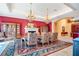 Spacious formal dining room with fireplace, built-ins, an ornate rug, and chandeliers at 5100 Cranes Point Ct, Orlando, FL 32839