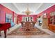 Formal dining room with a fireplace, ornate rug, and chandelier at 5100 Cranes Point Ct, Orlando, FL 32839