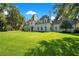 Elegant home exterior featuring a sprawling lawn and traditional architectural details at 5100 Cranes Point Ct, Orlando, FL 32839