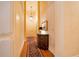 Hallway with hardwood floors, decorative walls, and an antique console table at 5100 Cranes Point Ct, Orlando, FL 32839