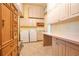 Bright laundry room with modern appliances, ample storage, and counter space for folding at 5100 Cranes Point Ct, Orlando, FL 32839