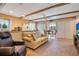 Cozy living room with wood beam ceilings, neutral decor, and access to the dining area at 5100 Cranes Point Ct, Orlando, FL 32839