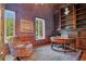 Inviting home office with custom built-ins, a round desk, and a comfortable armchair at 5100 Cranes Point Ct, Orlando, FL 32839