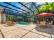 Relaxing screened-in pool area with lounge chairs and dining set, surrounded by lush landscaping at 5100 Cranes Point Ct, Orlando, FL 32839