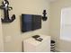 Bedroom featuring wall-mounted TV, dresser, and nautical-themed decor at 5123 Crown Haven Dr, Kissimmee, FL 34746
