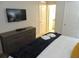 Bedroom featuring a TV, dresser, and comfortable bed with stylish linens at 5123 Crown Haven Dr, Kissimmee, FL 34746