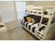Charming bunk bedroom with comfortable striped bedding and natural light at 5123 Crown Haven Dr, Kissimmee, FL 34746