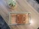 Close-up of a modern coffee table with a tic-tac-toe board game and decorative terrarium at 5123 Crown Haven Dr, Kissimmee, FL 34746
