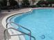 Community pool entrance with water and depth marker in the foreground at 5123 Crown Haven Dr, Kissimmee, FL 34746