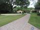 View down brick paver path to community pool and clubhouse at 5123 Crown Haven Dr, Kissimmee, FL 34746