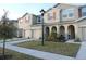Townhome exterior with manicured lawn, neutral color scheme and decorative shutters at 5123 Crown Haven Dr, Kissimmee, FL 34746