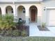 Welcoming front porch with cozy seating area and arched entryway at 5123 Crown Haven Dr, Kissimmee, FL 34746