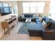 Comfortable living room with plush seating, stylish rug, and modern decor at 5123 Crown Haven Dr, Kissimmee, FL 34746