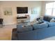 Cozy living room featuring a sectional sofa, TV, and decorative artwork at 5123 Crown Haven Dr, Kissimmee, FL 34746
