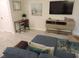 Cozy living room with a blue sectional sofa, TV, desk, and modern decor at 5123 Crown Haven Dr, Kissimmee, FL 34746