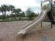 View of the community playground featuring a slide and swings at 5123 Crown Haven Dr, Kissimmee, FL 34746