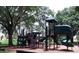 View of the community playground with multiple play features and climbing apparatus at 5123 Crown Haven Dr, Kissimmee, FL 34746