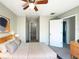 Inviting bedroom features ceiling fan, neutral paint, and ensuite bathroom, creating a comfortable and private retreat at 5126 Picadilly Circus Ct # 11, Orlando, FL 32839