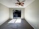 Bedroom with ceiling fan and sliding glass doors with a view of a deck at 5126 Picadilly Circus Ct # 11, Orlando, FL 32839