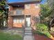 Charming two-story brick home featuring a balcony and well-maintained landscaping at 5126 Picadilly Circus Ct # 11, Orlando, FL 32839