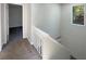Hallway featuring carpeted floors, a white wood banister, and a window at 5126 Picadilly Circus Ct # 11, Orlando, FL 32839