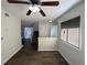 Open-concept living room with wood floors, ceiling fan, and staircase to the upper level at 5126 Picadilly Circus Ct # 11, Orlando, FL 32839