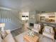 Bright living room featuring hardwood floors, fireplace, and an open kitchen concept at 5126 Picadilly Circus Ct # 11, Orlando, FL 32839