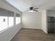 Living room featuring new wood floors, a ceiling fan, and sun-filled windows for natural light at 5126 Picadilly Circus Ct # 11, Orlando, FL 32839