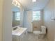 A view of a bathroom with updated mirror, sink, and toilet at 5600 Arundel Dr, Orlando, FL 32808