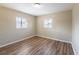 Bright bedroom featuring wood-look floors and dual windows for ample natural light at 5600 Arundel Dr, Orlando, FL 32808