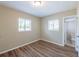 This bedroom has wood-look floors and two windows at 5600 Arundel Dr, Orlando, FL 32808