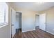 This bedroom features wood floors, a closet and a connected bathroom at 5600 Arundel Dr, Orlando, FL 32808