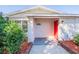 Inviting home entrance with a striking red door and charming outdoor lighting at 5600 Arundel Dr, Orlando, FL 32808