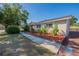 Landscaped front yard showcasing a well-kept house with a brick-lined garden bed at 5600 Arundel Dr, Orlando, FL 32808