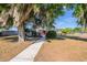 Quaint home shaded by a large tree with hanging Spanish moss, creating a serene setting at 5600 Arundel Dr, Orlando, FL 32808