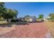 Cozy home featuring a brick driveway and mature trees, offering a welcoming curb appeal at 5600 Arundel Dr, Orlando, FL 32808
