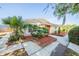 Well-maintained home with lush landscaping and a vibrant red front door at 5600 Arundel Dr, Orlando, FL 32808