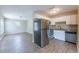 Modern kitchen with stainless steel appliances, white cabinets, and updated floors, adjacent to the dining area at 5600 Arundel Dr, Orlando, FL 32808